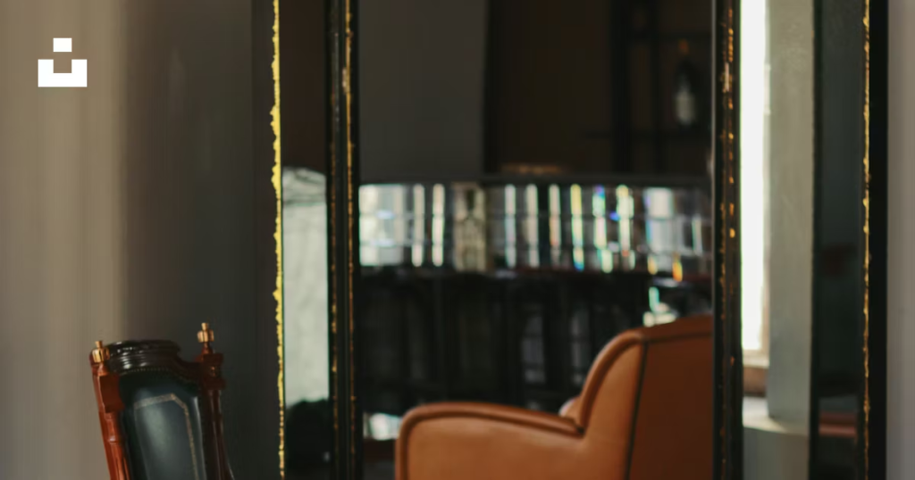 A living room filled with furniture and a tall mirror