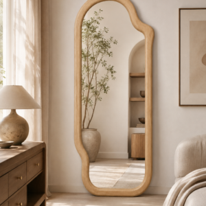 A warm modern bedroom setting showing how the sculptural mirror fits naturally into contemporary interiors.