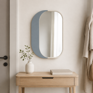 Small dusty blue decorative wall mirror displayed in a modern bedroom
