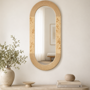 Styled in a warm, modern interior, the mirror brings soft natural texture and a refined decorative presence.