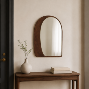 small walnut vanity mirror with brass detail in a boutique hotel dressing area