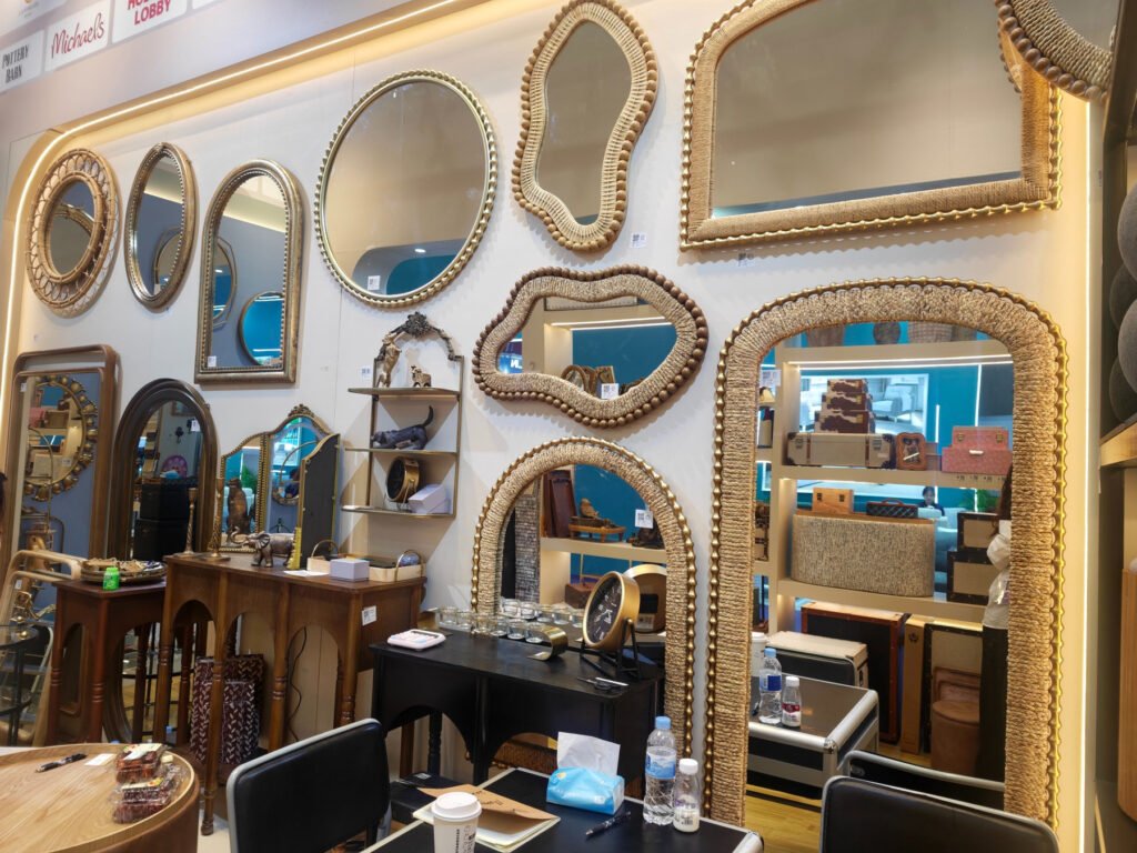 Decorative mirror display at Teruier Canton Fair booth with ornate gold-tone frames, curved shapes and textured designs.