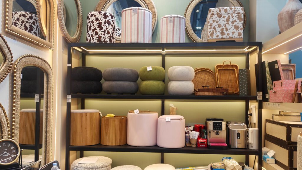 Wholesale upholstered ottoman and accent stool samples displayed in neutral, olive and blush colors at Teruier’s 2026 Canton Fair booth.