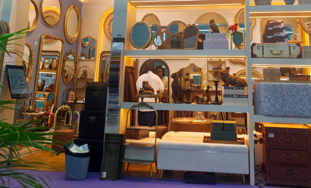 Wider view of Teruier’s Canton Fair home décor booth showing accent furniture and upholstered seating coordinated with mirrors and storage.