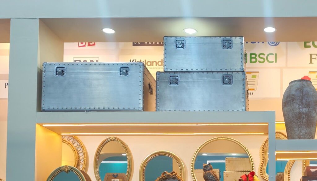 Metallic blue decorative storage trunks with corner hardware and latches at the Teruier exhibition booth