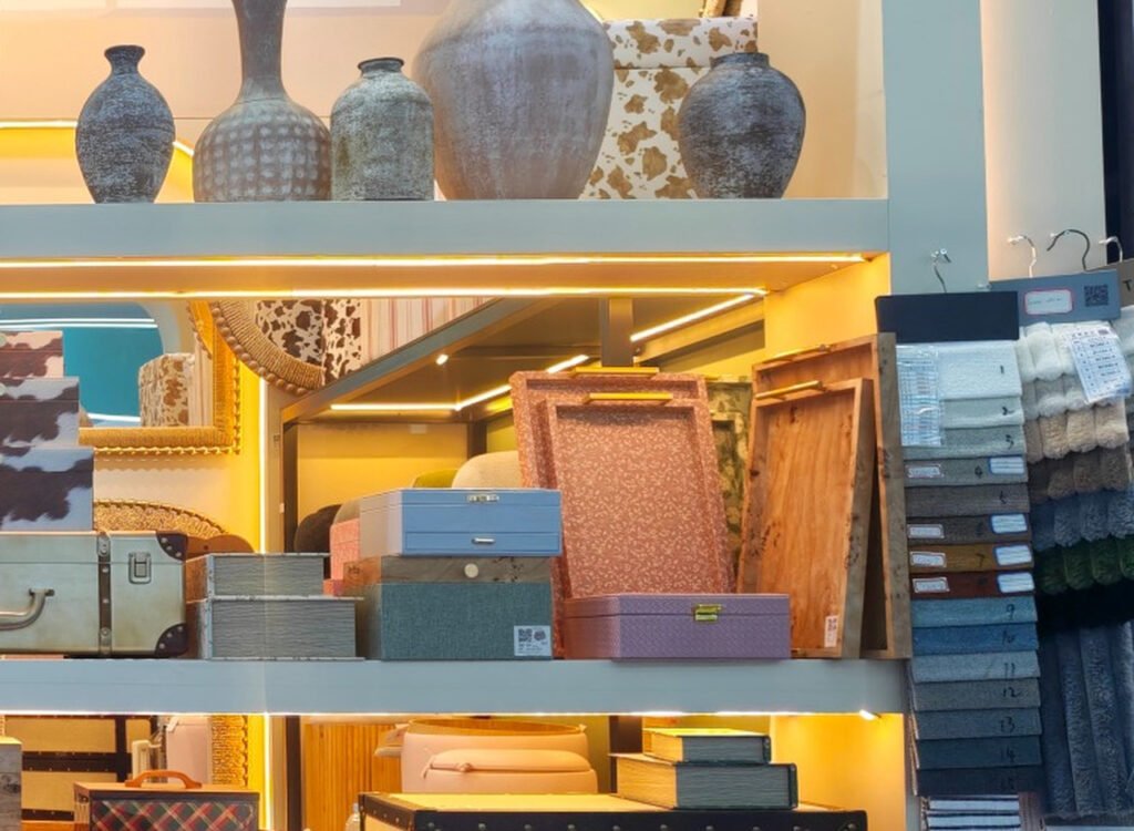 Patterned decorative boxes and compact storage cases arranged on shelves at the Teruier Canton Fair booth